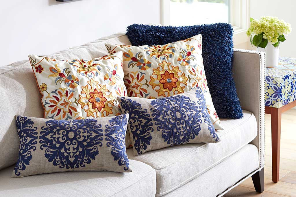 multip pillows with raised damask blue motif, lumbar shaped