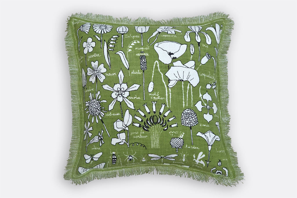 Two sided printed linen pillow in botanical illustrations of bugs and blossoms; green, white and black colors