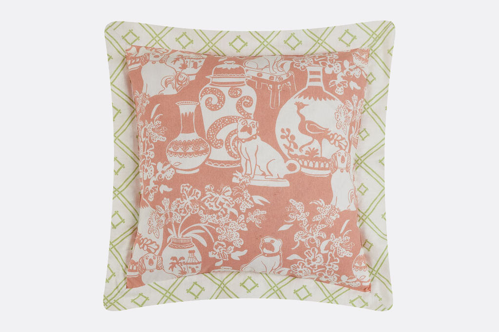 pastel pink and green chinoiserie style pillow shows print of dogs and vases