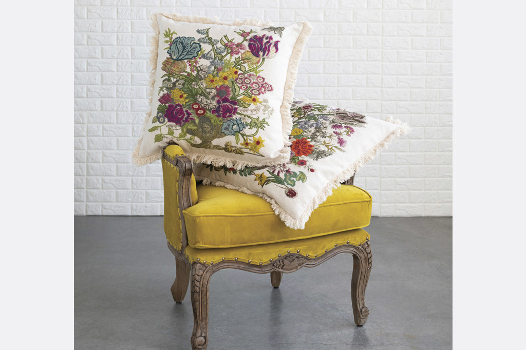 Pair of Large pillows shown on yellow velvet chair in room