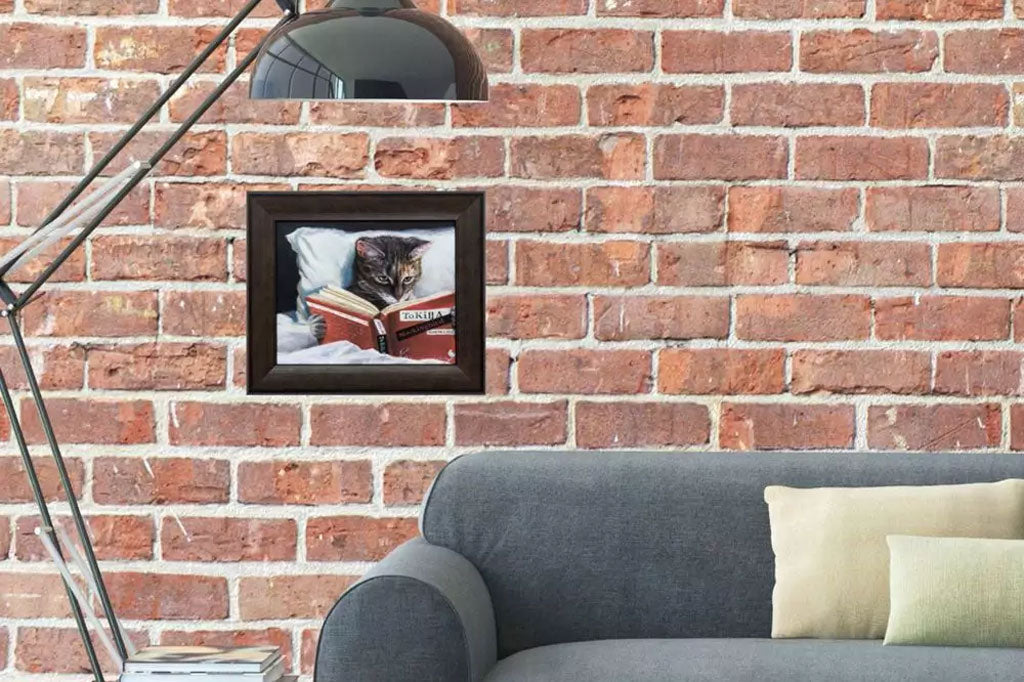 framed art of cat shown on brick wall in modern style home