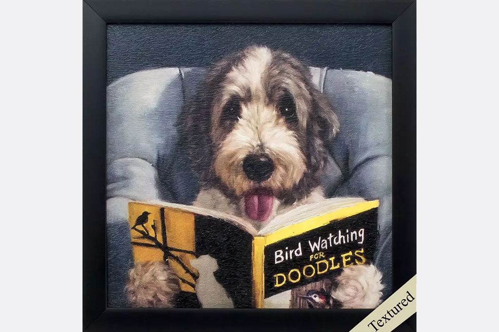 framed art print of dog reading in bed a book about bird watching