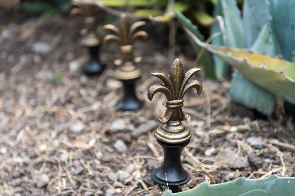 Alloro Hose Guard shown in series of three in garden