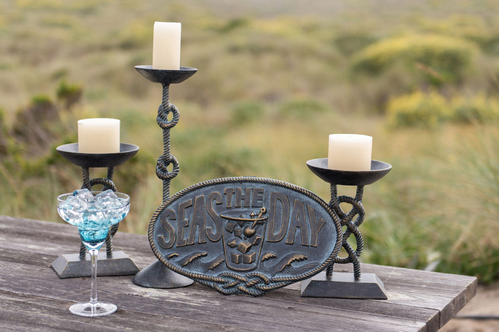 Seas The Day Plaque set against outdoor dining table with candelabras