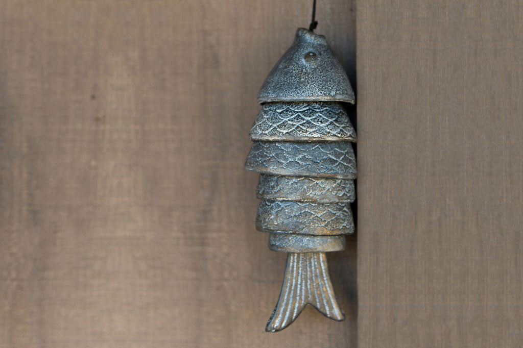 Fish Windchime shown agains home exterior