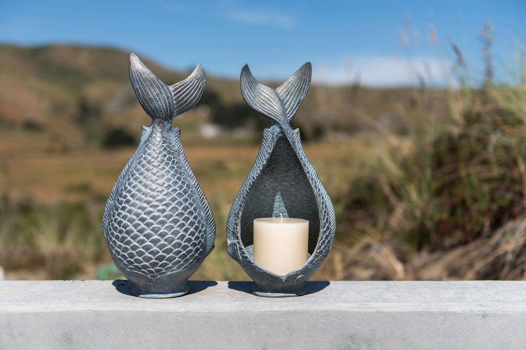 Diving Fish Candleholder shown in a pair on beach home wall by beach grass