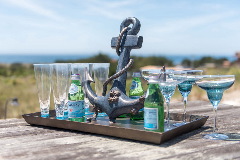 Anchor Tray shown at beach serving fizzy water on wood table