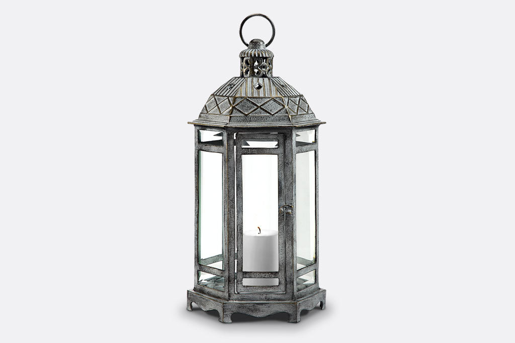 Sea Ranch Lantern in zinc finish with architectural style roof and 6 panes of glass. Shown with unlit 3"DIA white pillar candle.