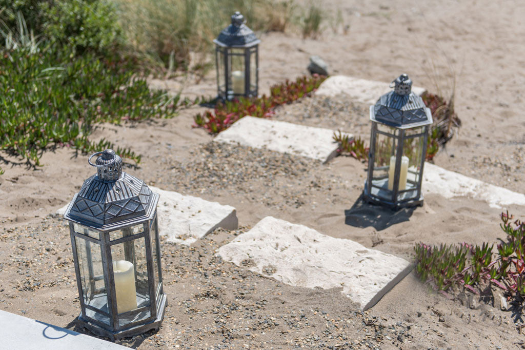 Sea Ranch Lanterns shown on sandy stairs at the beach next to iceplant