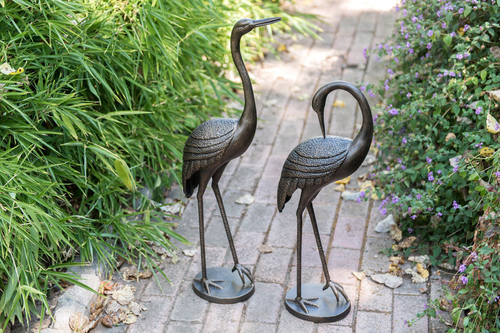 Courting Crane Couple sculptures shown on garden path
