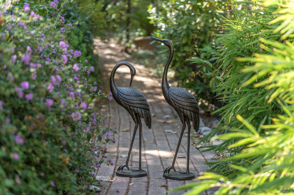 Courting Crane Couple sculptures shown on garden path