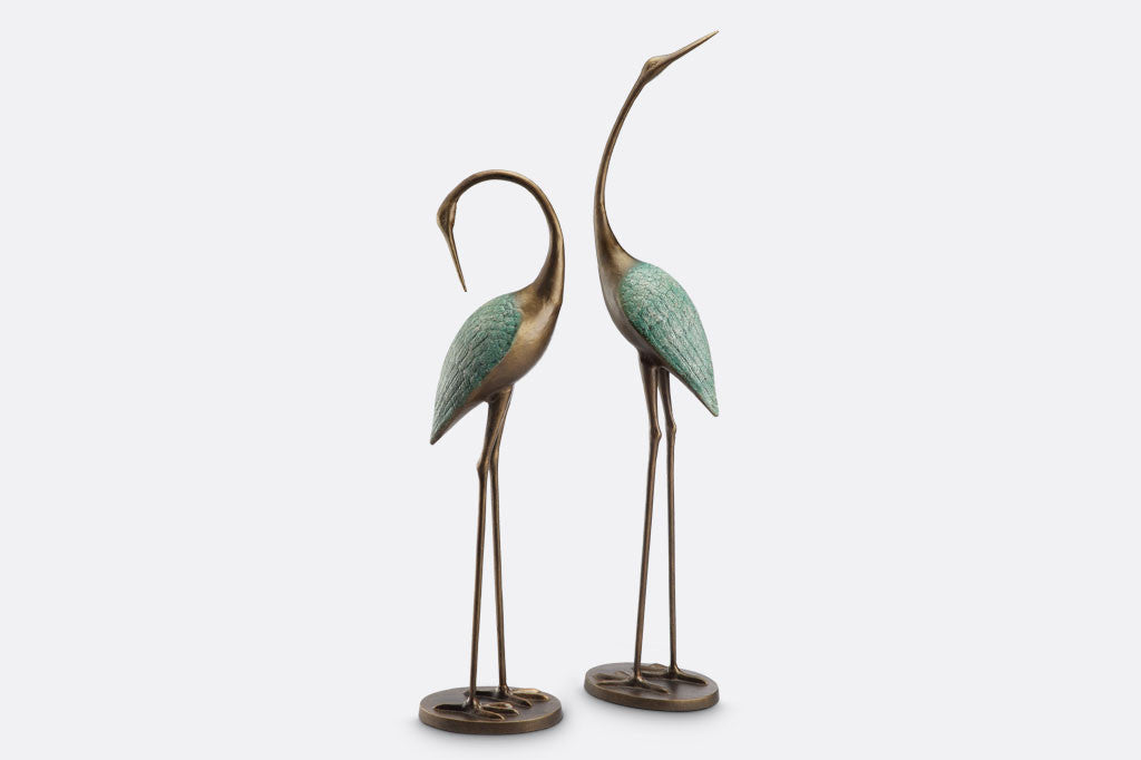 cast metal pair of cranes with blue detailing on feathers