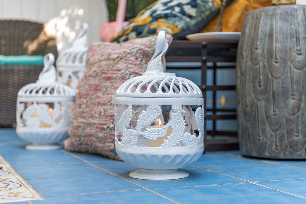 white cast metal swirling feather lantern on porch
#color_white