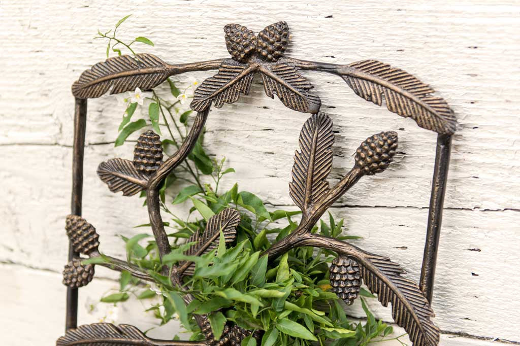 vines are twined upon the trellis featuring scattered pine branches