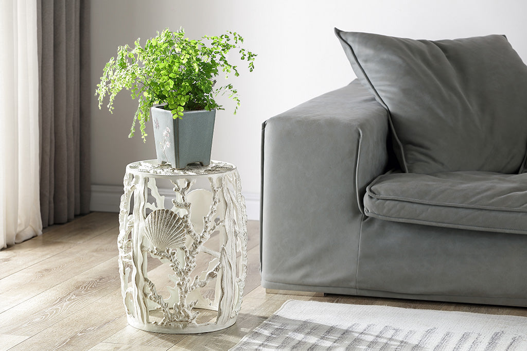 Sculptural ide pool themed metal stool in white and brushed gold finish. plant on stool by a grey couch
#color_white