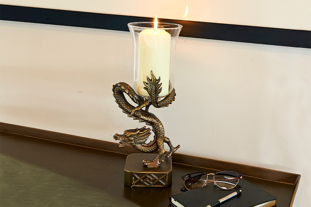 ming dragon candle holder on tray with glasses and a book