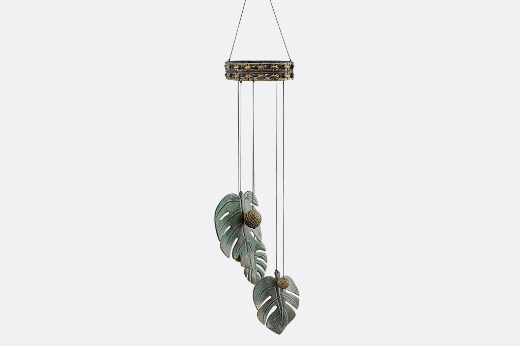 cast aluminum monstera leaf with circle ball knocker windchime