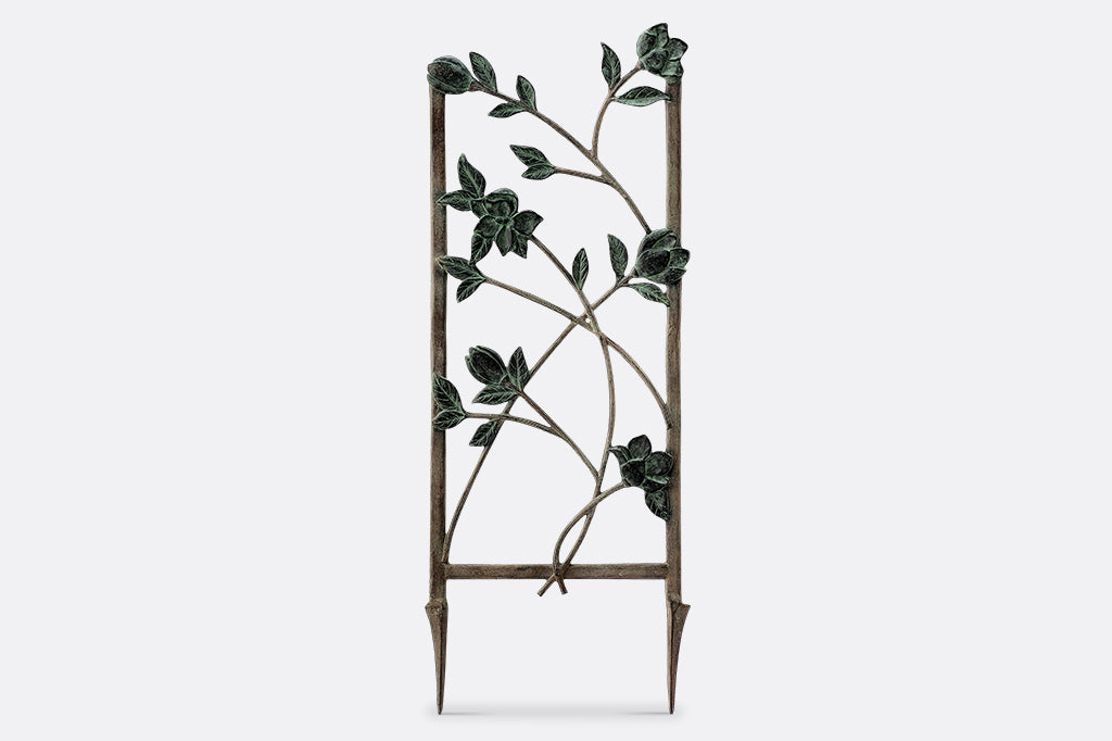 Magnolias Trellis Short shows verdigris blossoms and branches on a metal trellis frame