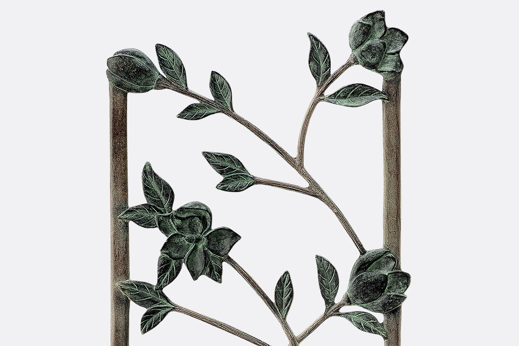 Close up view of Magnolias Trellis verdigris cast metal blossoms
