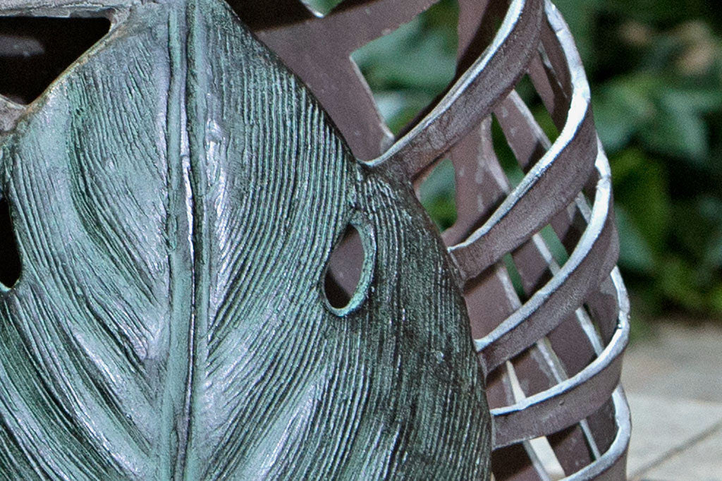 close up view of palm leaf motif shown on garden stool