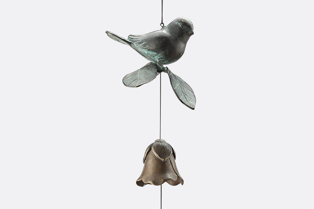 Cast brass bird and blossom shaped bell wind art