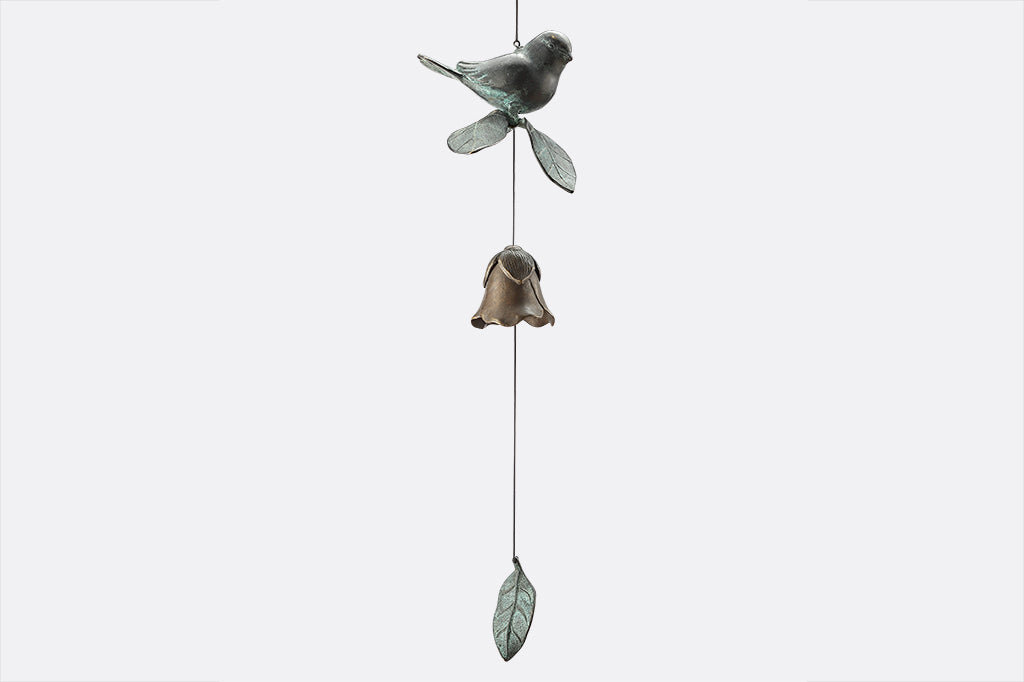 Cast brass bird and blossom shaped bell wind art