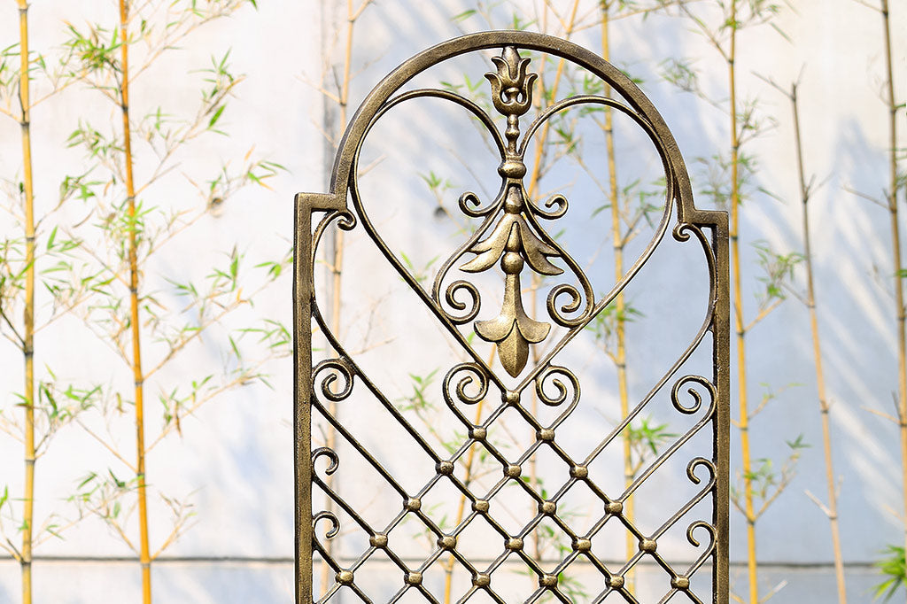 garden trellis in bronze with fleur de Lys and scrollwork motifs