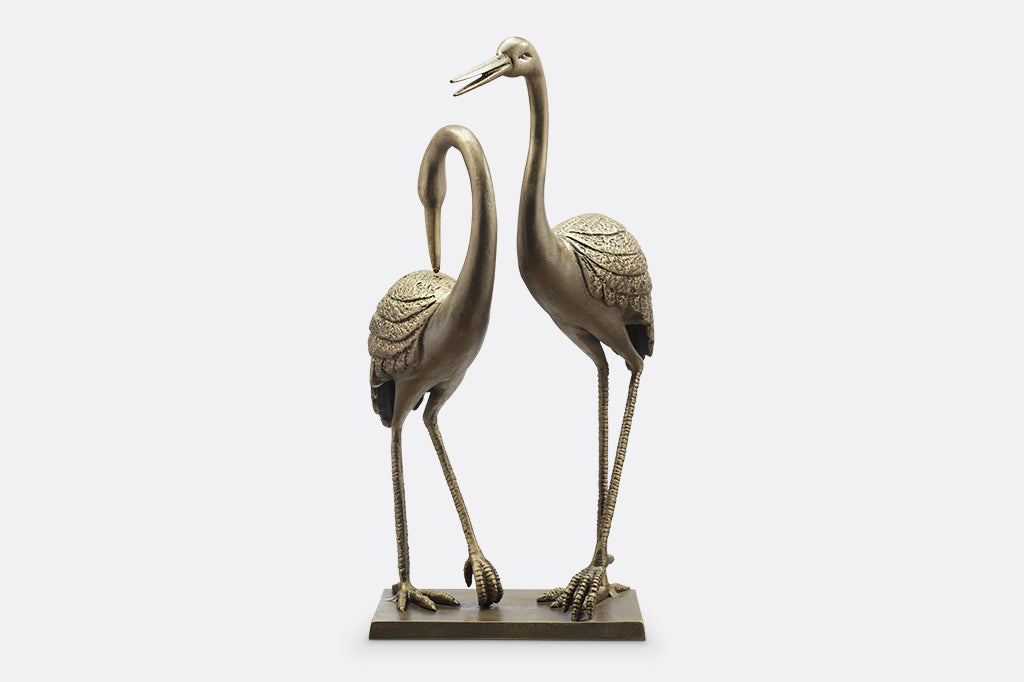 cast metal cranes on rectangle base