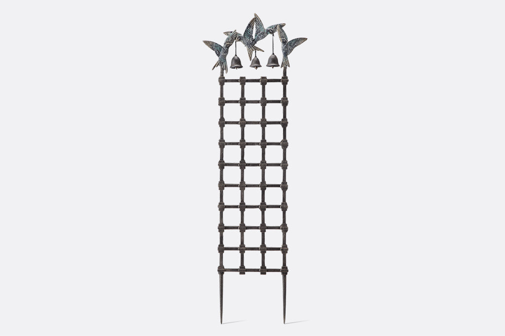geometric grid trellis of Mission style topped by 4 swallows holding bells