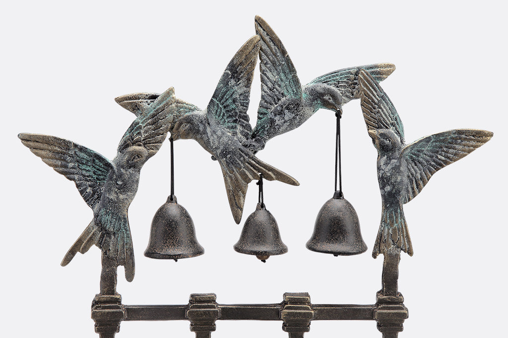 View of sculpted swallows holding 3 bells