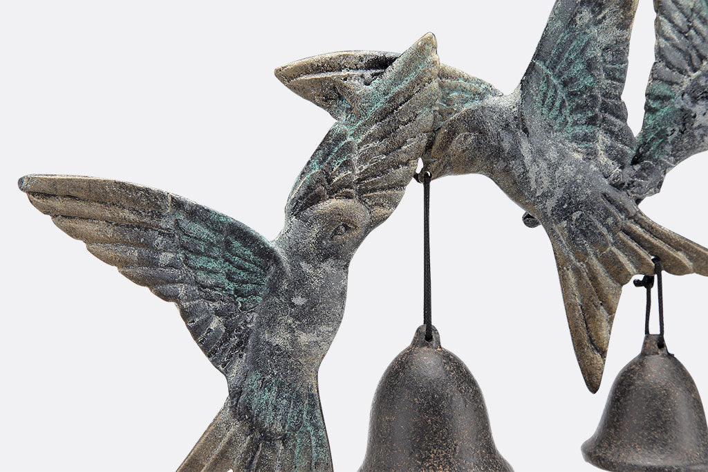 View of sculpted swallows holding 3 bells