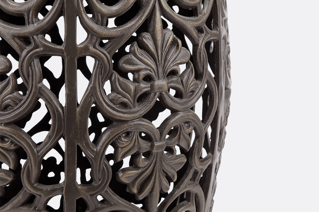 Elaborate floral scrollwork on cast metal stool