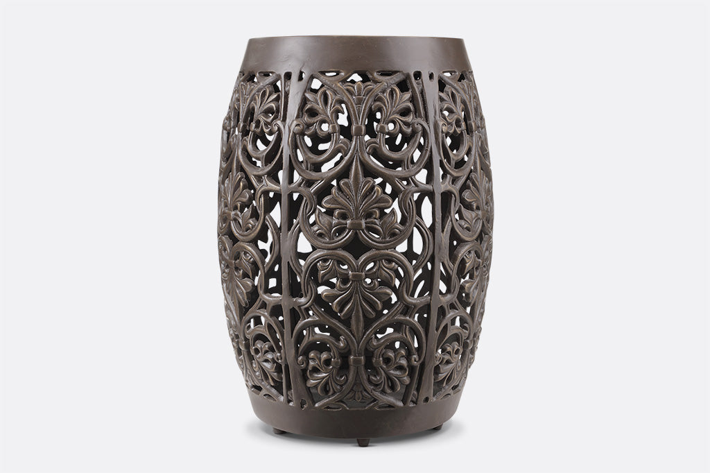 Elaborate floral scrollwork around a garden stool in brown finish