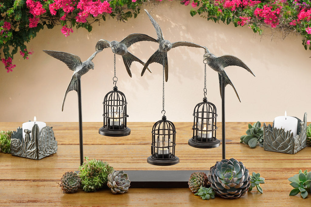 hanging lantern table sculpture with 4 sculpted swallows holding 3 candle birdcages