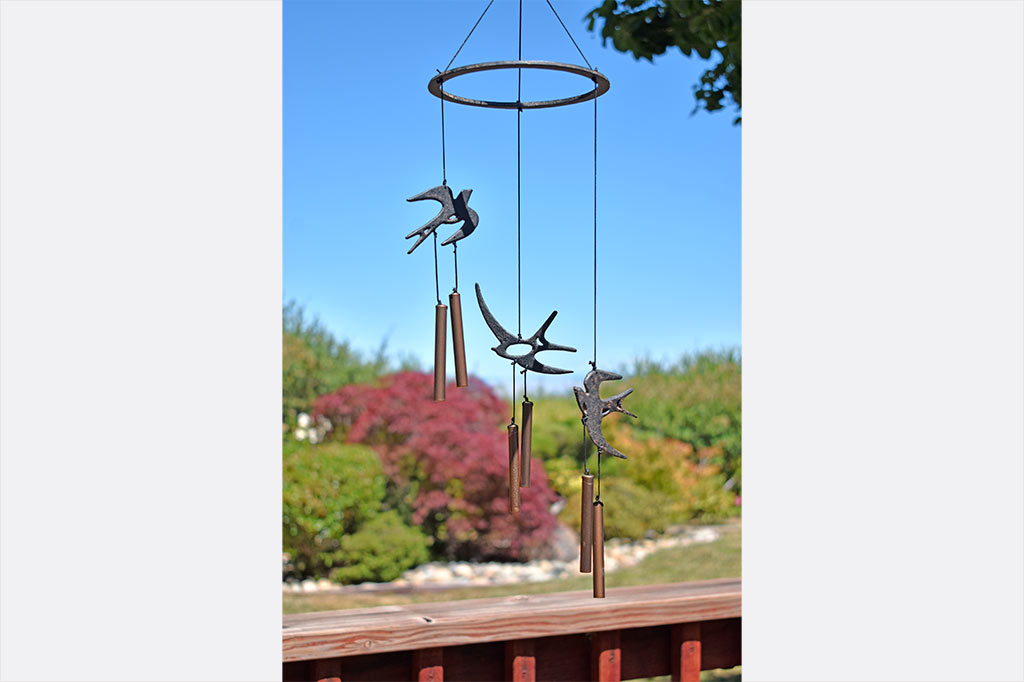 Circular Ring has three swallows and chimes suspended from it as wind art