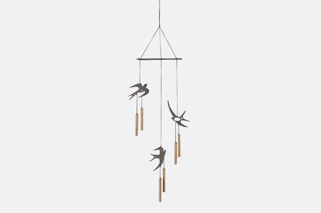Circular Ring has three swallows and chimes suspended from it as wind art