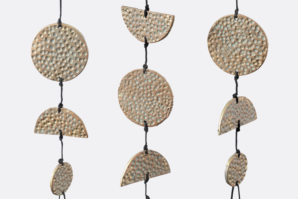 detailed view of the textured hammered surface of the geometric chimes