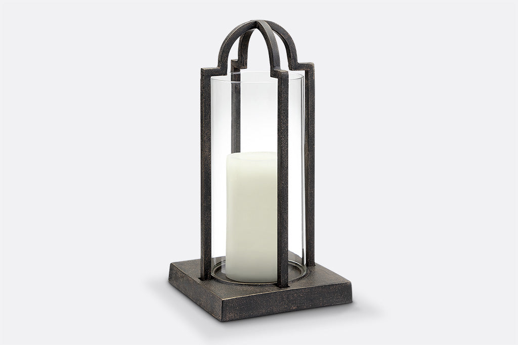 cast metal and glass lantern, geometric square base holding white candle