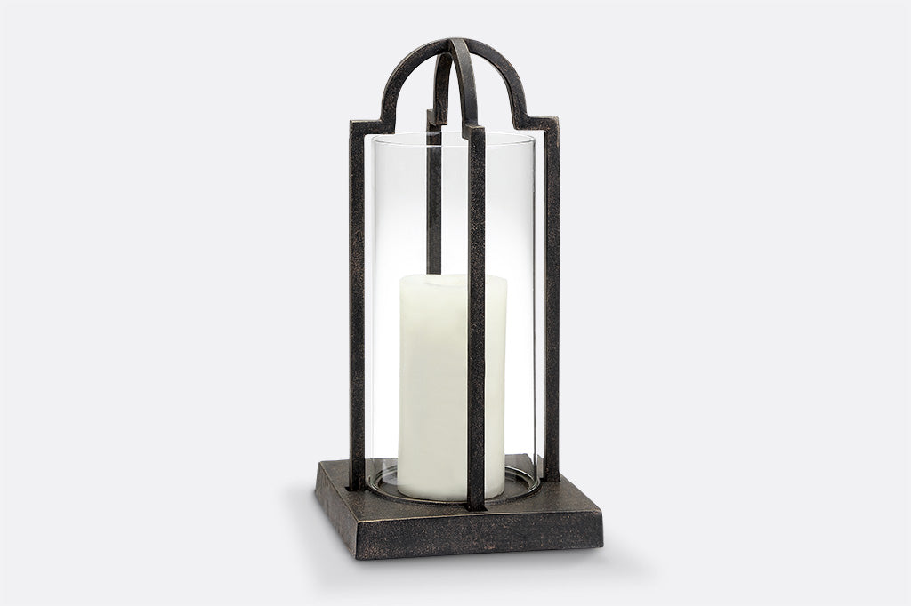 cast metal and glass lantern, geometric square base holding white candle