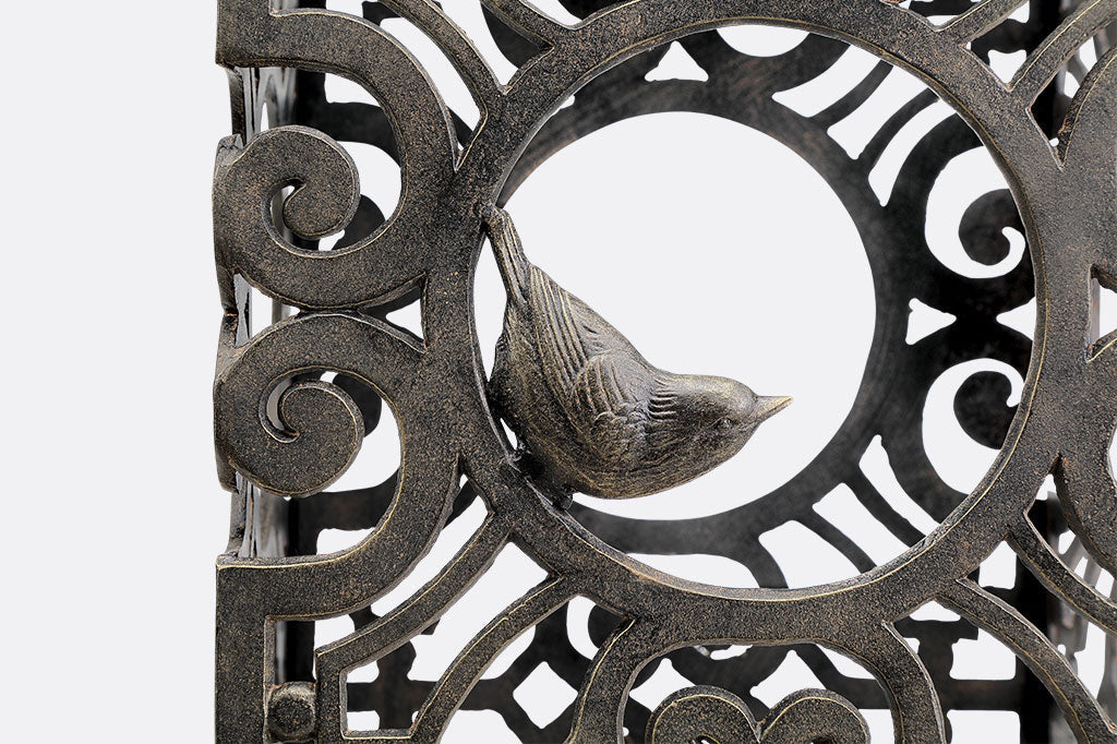 closeup view of Acantilado stool featuring Capistrano scrollwork and swallow bird sculpted in circular opening
#color_Espresso Bronze