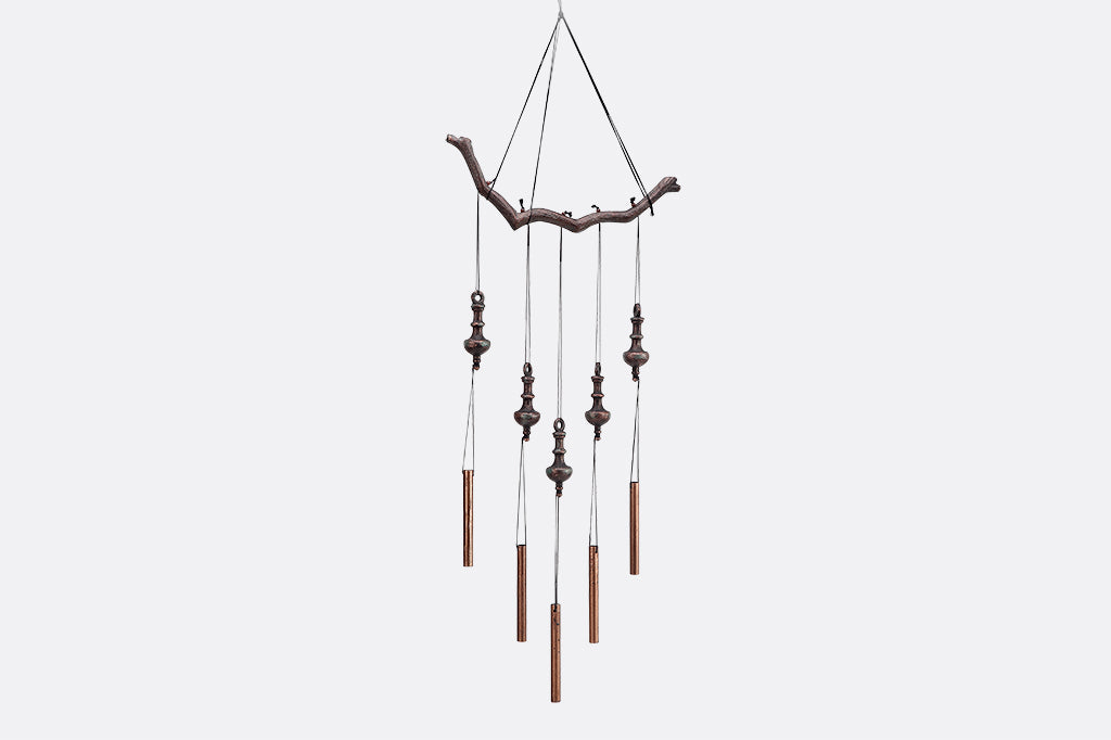 hanging sculpture of rods and tops suspended from branch motif