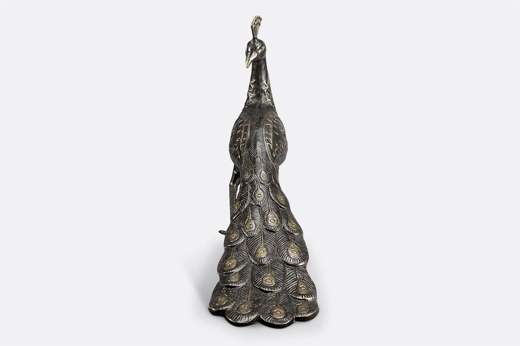 cast metal peacock bird bath, with feathers creating the base of the bird bath
