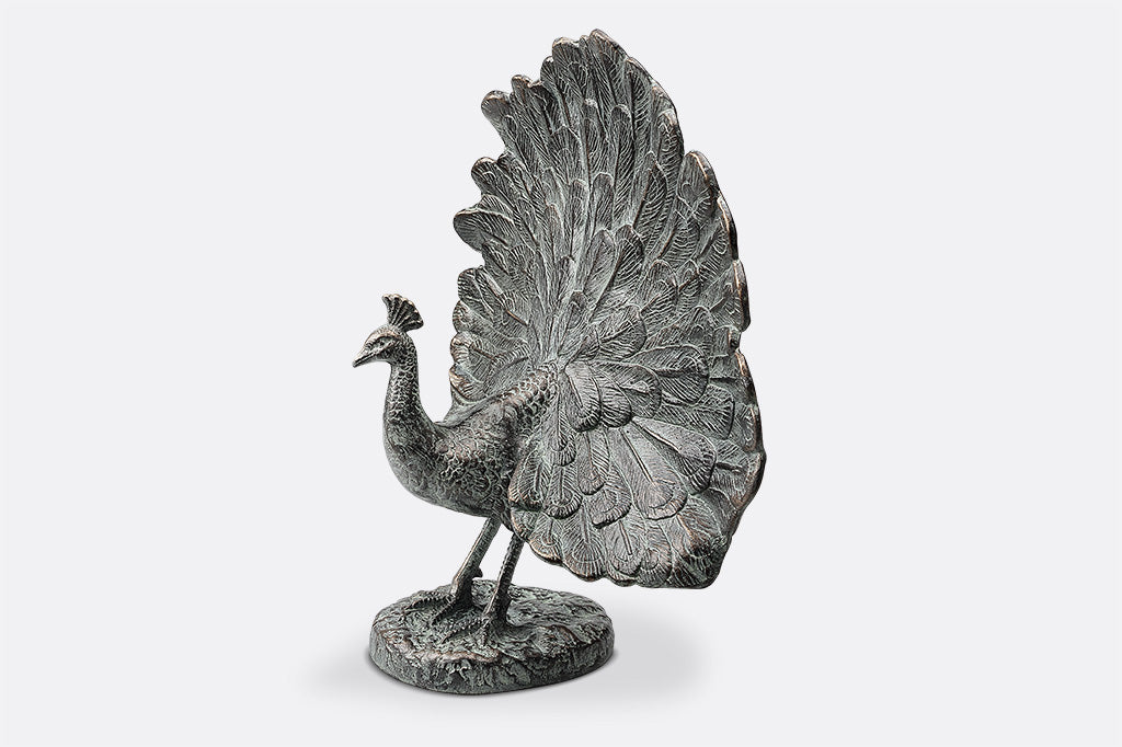 cast metal peacock with feathers fanned out