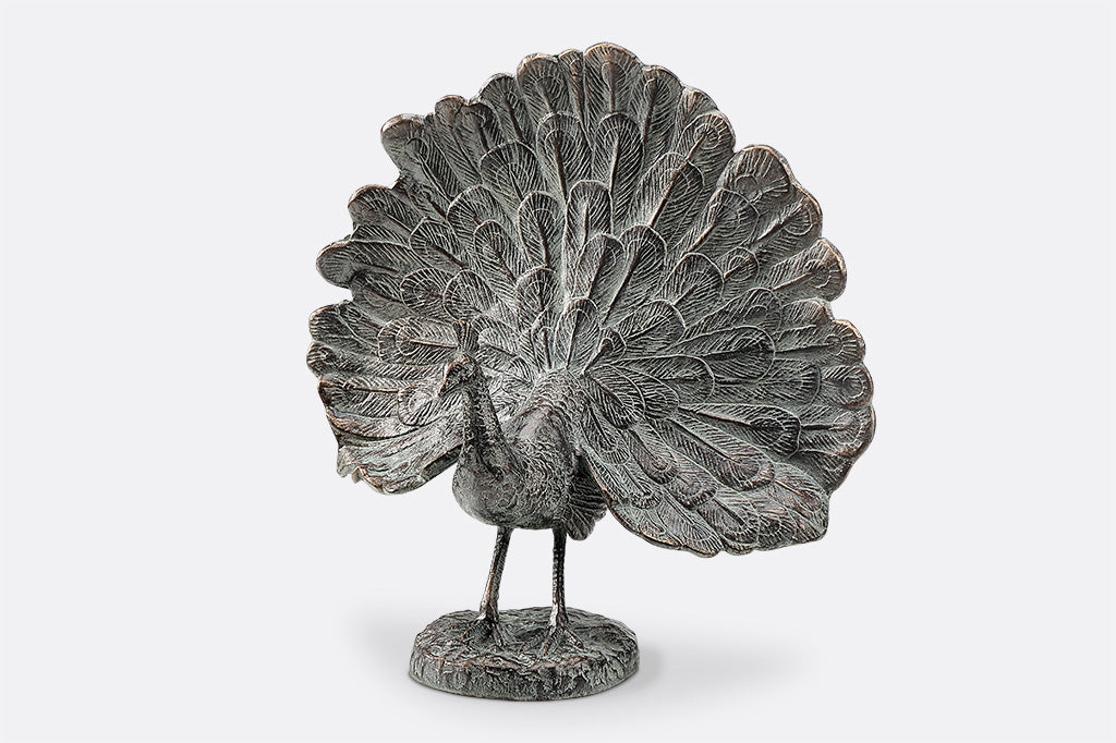 cast metal peacock with feathers fanned out