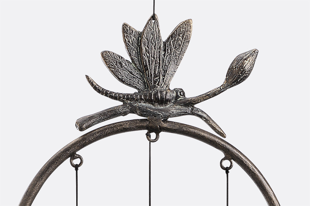 close up view of lily and dragonfly on wind bells in circle with dragonfly and lily motif