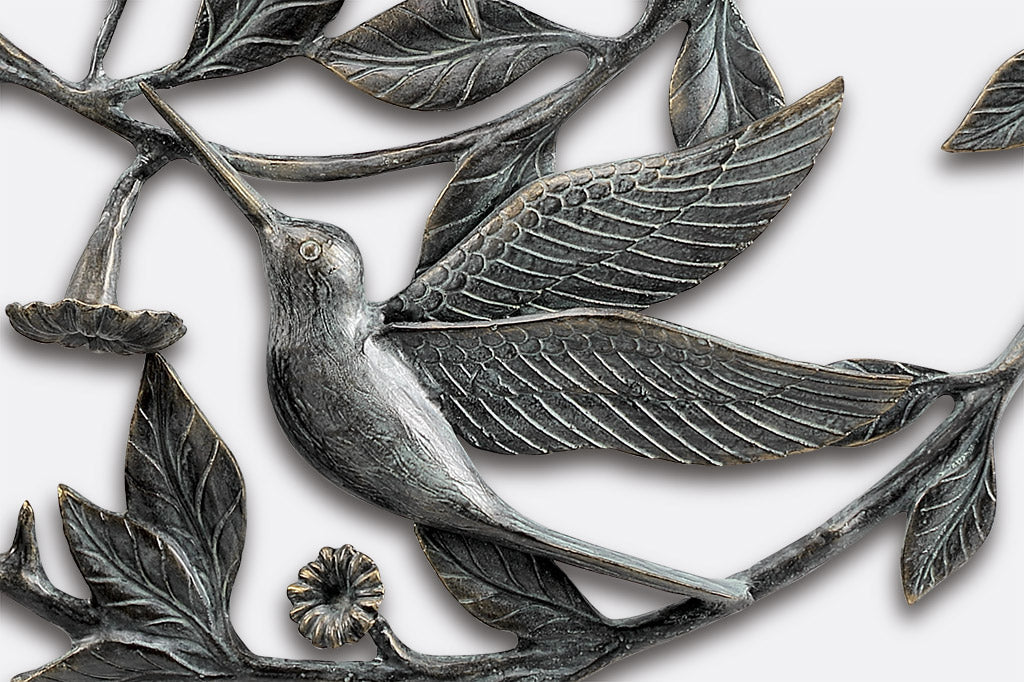 View of the second sipping hummingbird on a sculptural wall art
