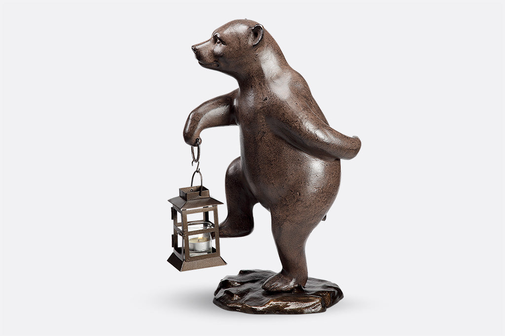 Face left: Garden bear holds lantern and picks up right foot mid-step
