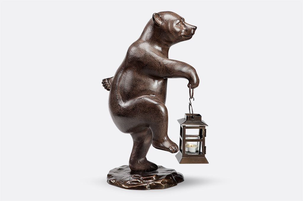 Face right: Garden bear holds lantern and picks up right foot mid-step