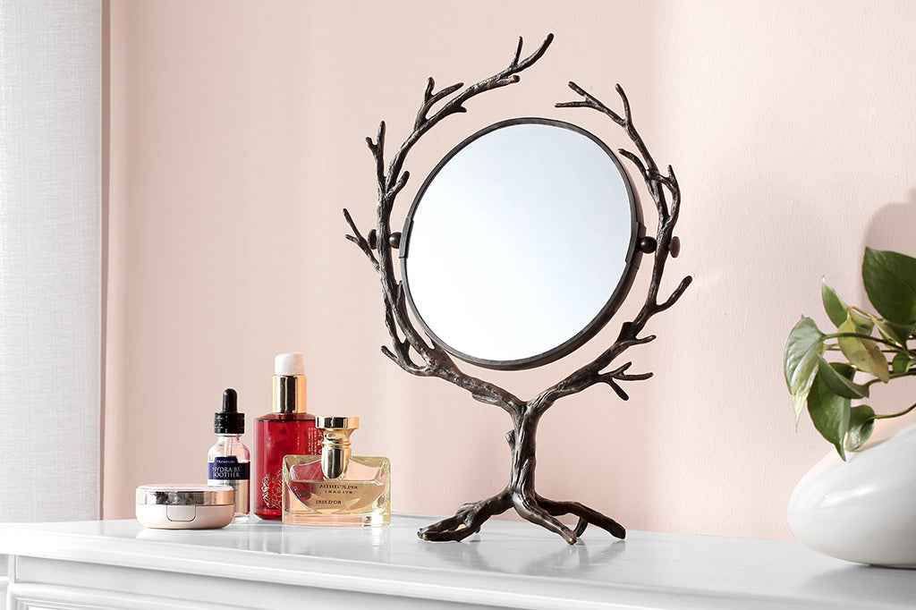 tree and branch theme for a two-sided vanity mirror placed upon vanity table in pink room