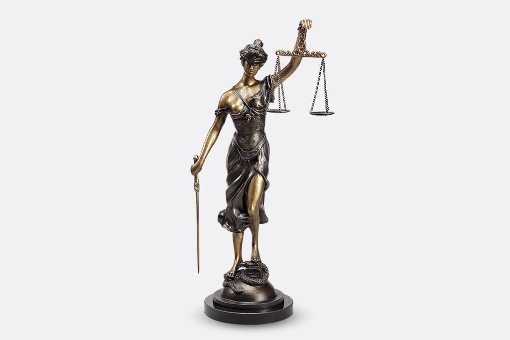 Classic office sculpture of lady justice, complete with scales and sword
